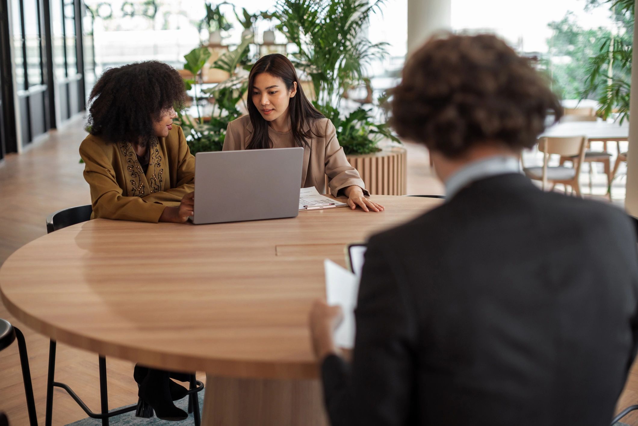 Professionals discussing hiring strategy in an office