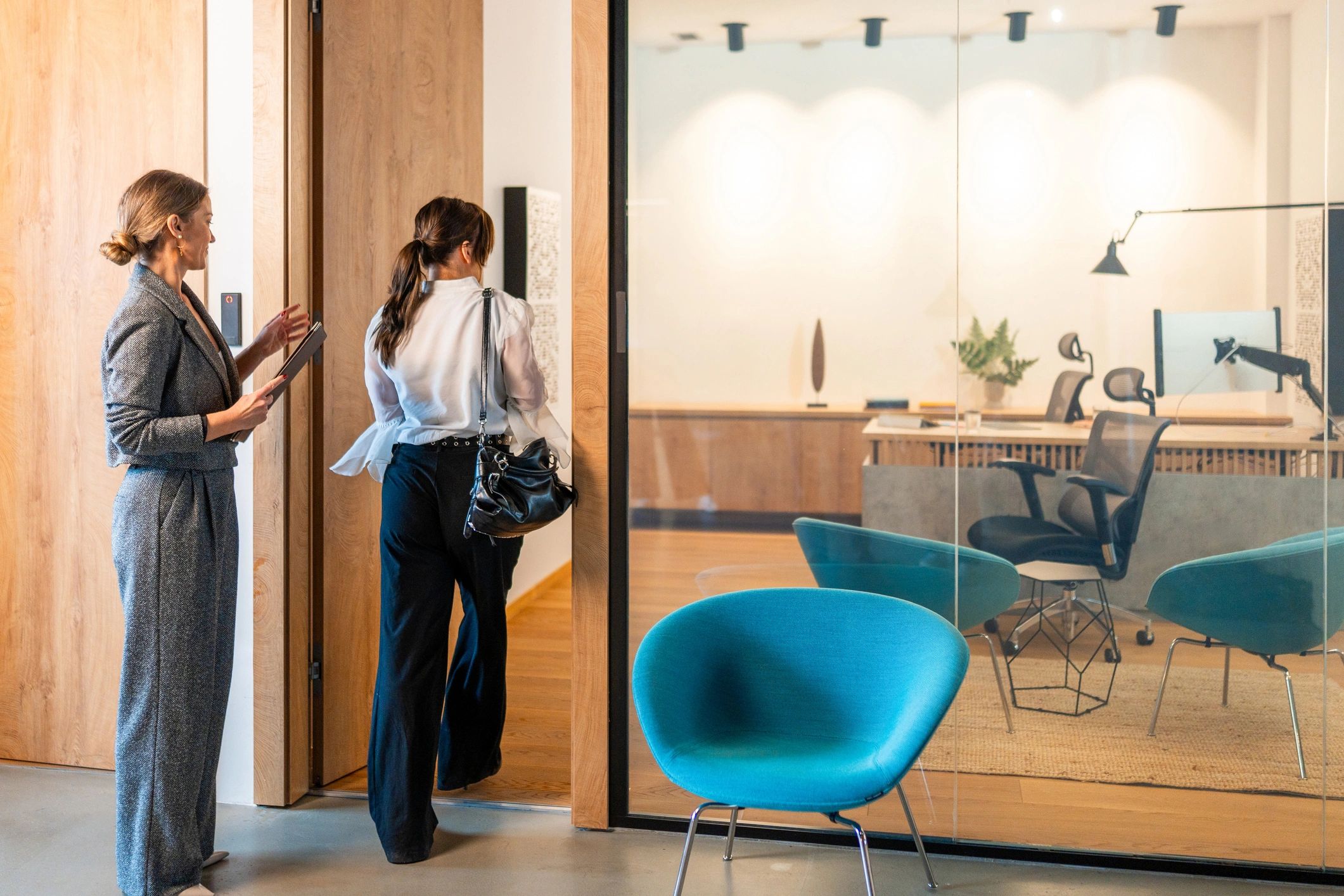 Candidate being guided into a professional interview setting